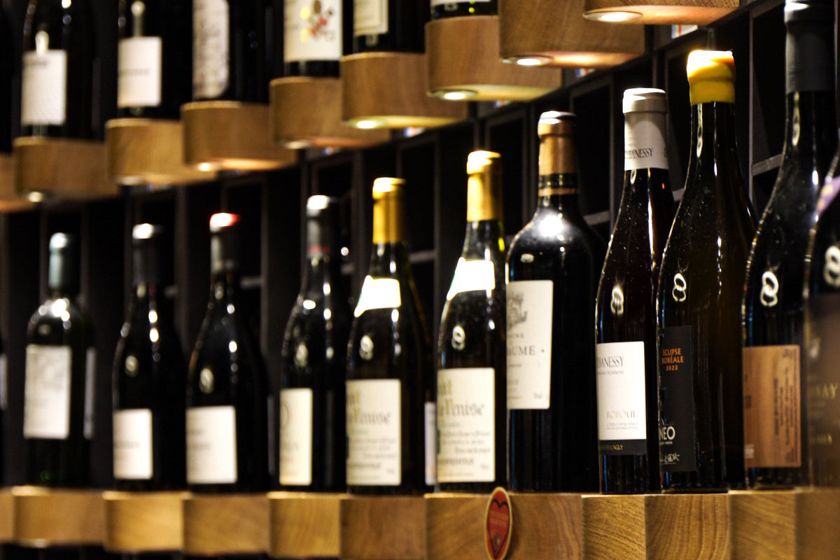 Beleuchtete Weinregale mit Flaschen großer Weine in einem Weinkeller